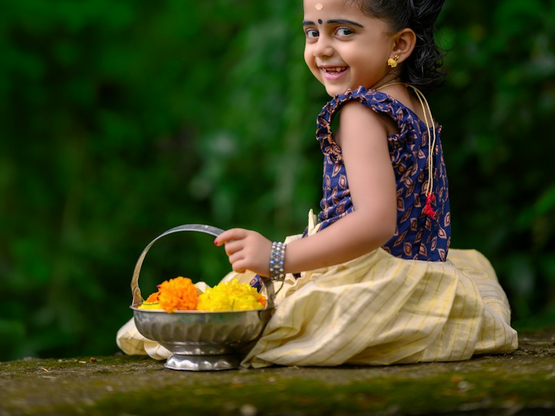 Smiling girl in a traditional pattu pavadai with flowers