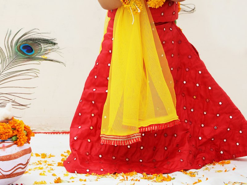 Girl in a red pattu langa with yellow dupatta