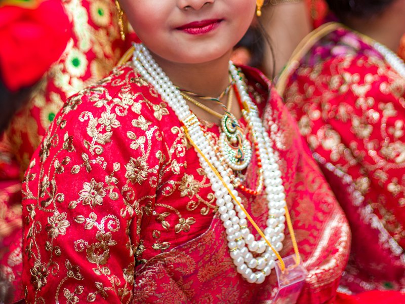 Girl in a red and gold traditional dress