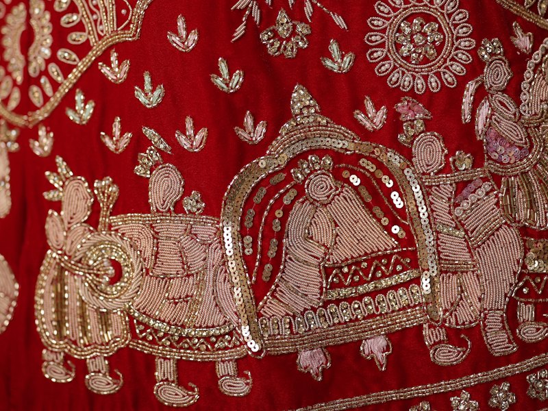 Gold zardosi and maggam embroidery on red fabric